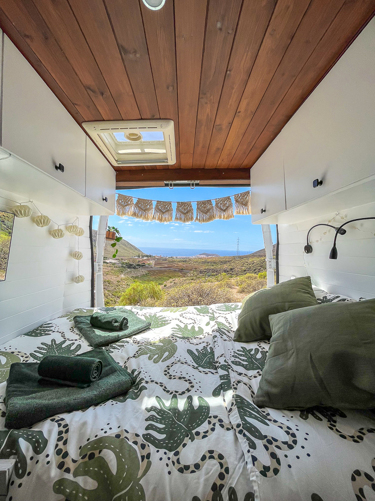 The bed and view of La Pinta, one of our camper vans available to rent in Tenerife